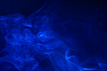 Blue smoke on black background.