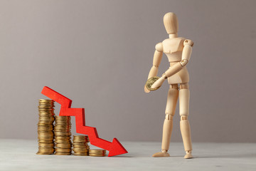 Coins down staircase and down arrow arrows. A businessman carries a coin making an investment. Drop in profits or bankruptcy.