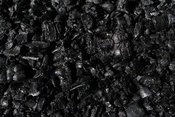 black ash with highlights from the sun close-up fills the entire frame, creating an impressive texture