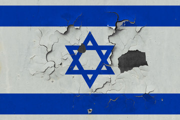 Close up grungy, damaged and weathered Israel flag on wall peeling off paint to see inside surface.