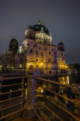 Fototapeta premium Beautiful view of illuminated Berliner Dom (Berlin Cathedral) by the Spree River in Berlin, Germany, at dusk.