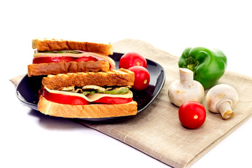 Fresh toast with mushrooms, pepper, tomato, cheese and sausage on white background close-up