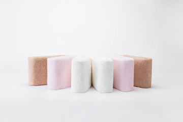 Stacked white, pink, apricot towels
