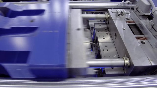 Automatic plastic injection molding machine.