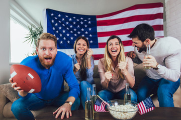 Friends cheering sport league together