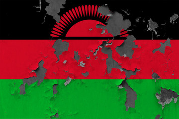 Close up grungy, damaged and weathered Malawi flag on wall peeling off paint to see inside surface.
