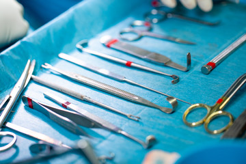 Set of sterile instruments laid out on the table for an operation on a blue cloth