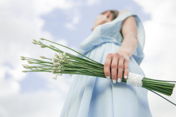Beautiful bride in blue dress with simple elegant bouquet 