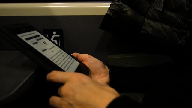 woman reads in Austrian train a book on a table