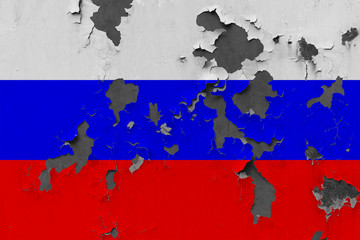 Close up grungy, damaged and weathered Russia flag on wall peeling off paint to see inside surface.