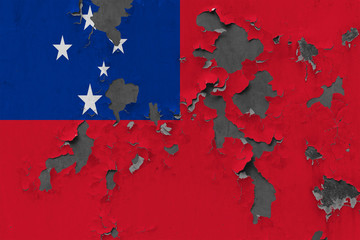Close up grungy, damaged and weathered Samoa flag on wall peeling off paint to see inside surface.