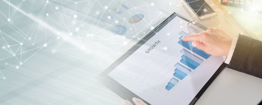 Businesswoman pointing her finger on a graph