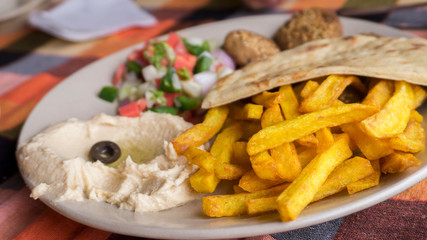 Closeup French fried with humus and pita plate