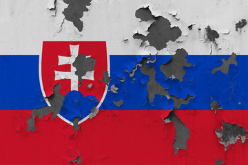 Close up grungy, damaged and weathered Slovakia flag on wall peeling off paint to see inside surface.