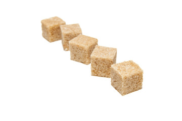 Brown cane sugar cubes isolated on white