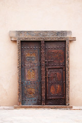 Old wooden decorated door in Oman