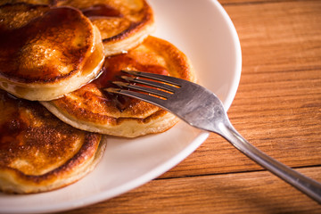 Fresh homemade pancakes on rustic wooden table