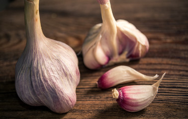 Raw organic garlic on rustic wooden background. Selective focus.