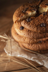 Fresh chocolate americana cookies on wooden table. Chocolate chip cookies on rural background.