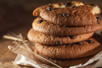 Fresh chocolate americana cookies on wooden table. Chocolate chip cookies on rural background.