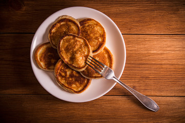 Fresh homemade pancakes on rustic wooden table