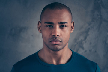 Fototapeta premium Close-up portrait of his he nice attractive minded calm peaceful candid guy wearing casual style trendy blue t-shirt over gray industrial concrete wall