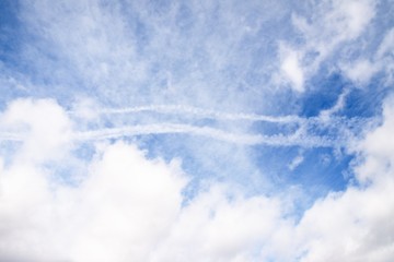 Beautiful white fluffy and cirrocumulus clouds on a blue sky background