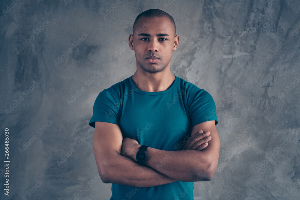 Wall mural Portrait of his he nice attractive sportive strong powerful guy wearing trendy blue t-shirt modern smart watch clock isolated over gray industrial concrete wall - Wall murals
