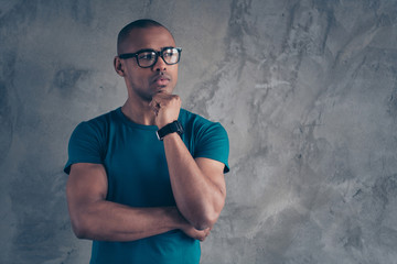 Portrait of his he nice lovely attractive muscular virile good-looking masculine guy wearing blue t-shirt modern new device digital watch isolated over gray industrial concrete wall
