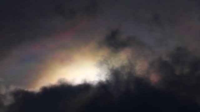 Dramatic iridescent multicoloured time lapse stormy tropical skies with rainbow pastel colours forming. Natural majestic phenomenon.
