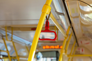 Red handrails in an empty bus