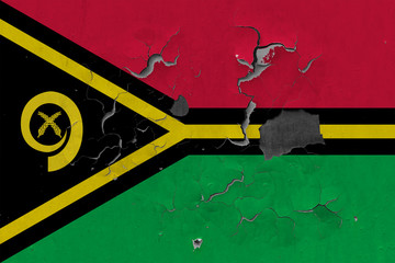 Close up grungy, damaged and weathered Vanuatu flag on wall peeling off paint to see inside surface.