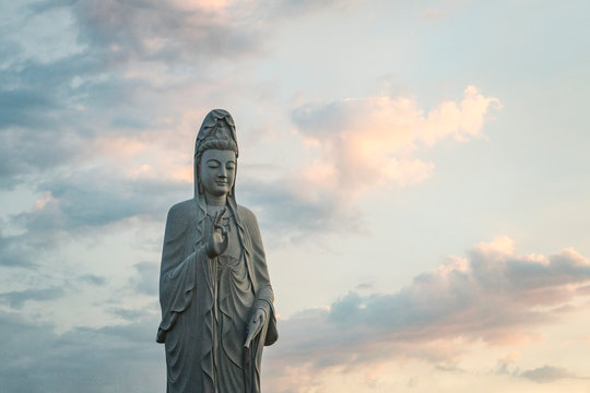 Lady Buddha against the cloudy sky in a Buddhist temple. MUI ne.