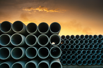 Row of Drainage Sewage Concrete Pipeline Storage, Stack of Culvert Pipe and Waste Water Treatment System of Manufacturing Plant. Cement Water Culvert Pipes for Construction