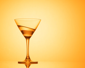 Martini glass on color background