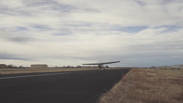 Close view of a plane taking off on a runway with a cloudy sky