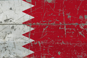 Grunge Bahrain flag on old scratched wooden surface. National vintage background.