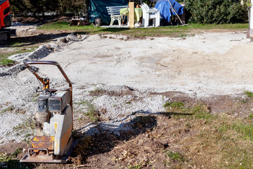 Unterbau einer Terrasse mit Betonbruch , mit Verdichtung des Bodens durch eine Rüttelplatte.
