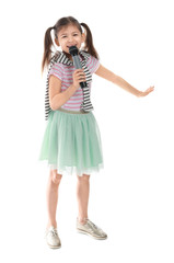Little girl with microphone singing against white background
