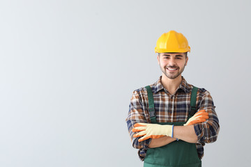 Male worker on light background