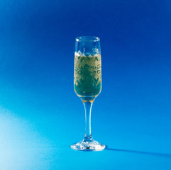 glass of water with ice on blue background