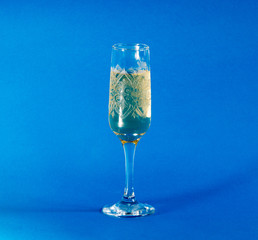 glass of champagne on blue background