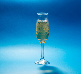 glass of water on background of blue sky