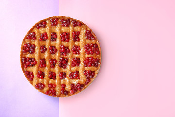 Tasty cranberry pie on color background