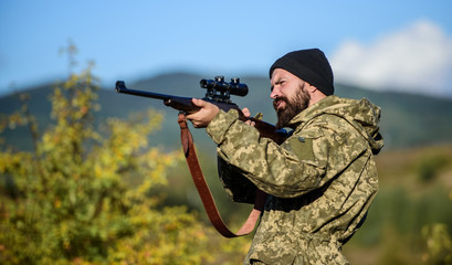 Hunting and trapping seasons. Hunting masculine hobby. Man brutal gamekeeper nature background. Hunter hold rifle. Bearded hunter spend leisure hunting. Focus and concentration of experienced hunter