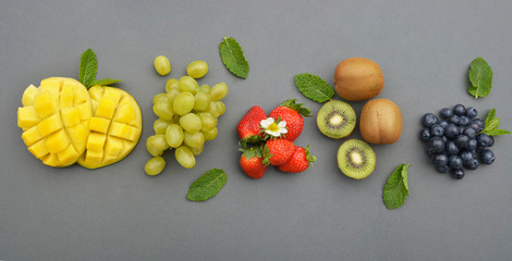 Banner from various fruits isolated on grey background, top view, creative flat layout. Concept of healthy eating, food background.