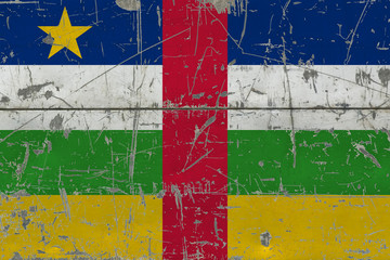 Grunge Central African Republic flag on old scratched wooden surface. National vintage background.