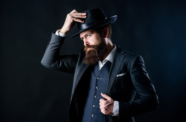 Man with hat. Man well groomed bearded gentleman on dark background. Male fashion and menswear. Retro fashion hat. Formal suit classic style outfit. Elegant and stylish hipster. Vintage fashion