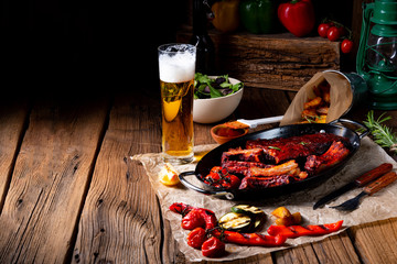 Grilled ribs in spicy marinade with salad and vegetables