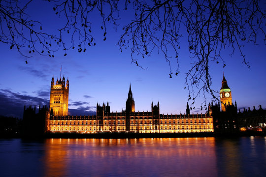 Spooky Night view of Palace of Westminster over dramatic blue sky